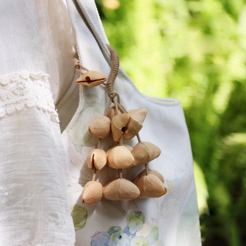 Fruit shell backpack hanging bell